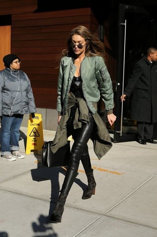 Gigi Hadid wearing Black Leather Skinny Jeans, Black Sleeveless Top, Olive Bomber Jacket, Olive Military Jacket