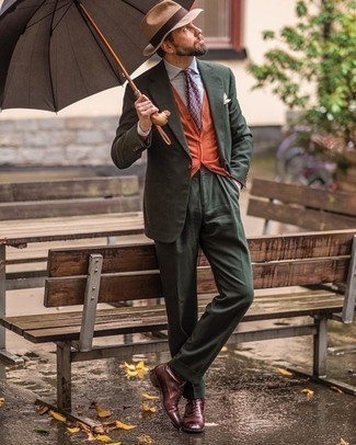 Orange Cardigan Outfits For Men: Choose an orange cardigan and a dark green suit to ooze elegance and polish. Dark brown leather oxford shoes will polish up any ensemble.