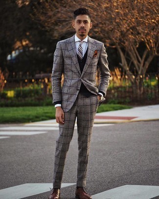 For masculine sophistication with a twist, consider teaming a brown plaid wool suit with a black cardigan. The whole outfit comes together quite nicely if you complete your look with a pair of dark brown leather brogues.