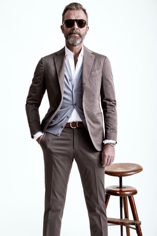Wear a brown suit and a grey cardigan for a proper elegant ensemble.