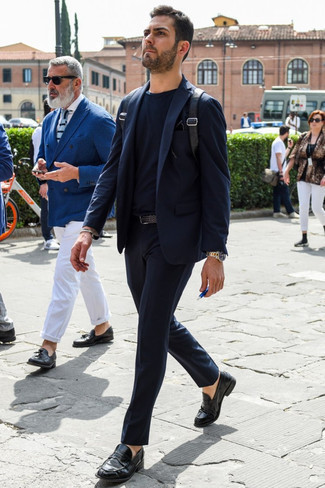 Black Backpack Outfits For Men: This pairing of a navy suit and a black backpack is super easy to imitate and so comfortable to rock a version of throughout the day as well! Black leather loafers are a surefire way to bring a touch of sophistication to your outfit.
