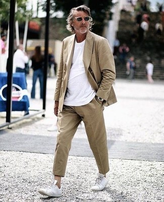 Suit Smart Casual Outfits After 50: A suit and a white crew-neck t-shirt are the kind of a foolproof ensemble that you so terribly need when you have no time. A pair of white leather low top sneakers effortlessly bumps up the appeal of your ensemble. This pairing proves that even after 50 your sartorial options are still rather broad.