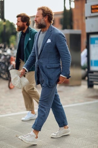 Navy Plaid Suit Outfits: A navy plaid suit and a light blue crew-neck t-shirt are a great combo that will earn you the proper amount of attention. White leather low top sneakers will bring a fun vibe to an otherwise sober look.