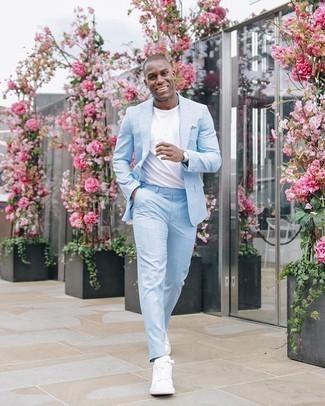 Light Blue Suit Outfits: Such must-haves as a light blue suit and a white crew-neck t-shirt are an easy way to infuse a touch of manly sophistication into your current casual lineup. A pair of white canvas low top sneakers adds a little edge to this outfit.