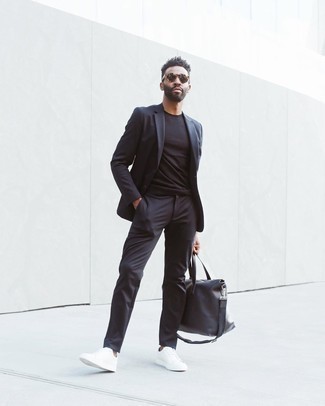 Black Leather Duffle Bag Outfits For Men: Opt for a charcoal suit and a black leather duffle bag and you'll look like the dapperest dude around. A pair of white canvas low top sneakers looks awesome finishing off your ensemble.
