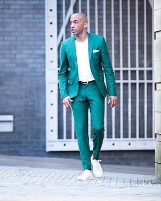 Green Suit Outfits: You'll be amazed at how easy it is for any man to get dressed like this. Just a green suit combined with a white crew-neck t-shirt. White canvas low top sneakers are the simplest way to bring a hint of stylish effortlessness to this outfit.