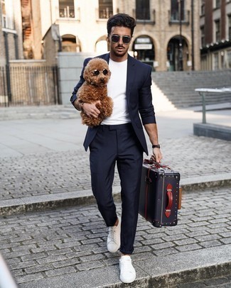 Black Suitcase Outfits For Men: A navy suit and a black suitcase will give off this casually dapper vibe. If in doubt about the footwear, stick to white canvas low top sneakers.