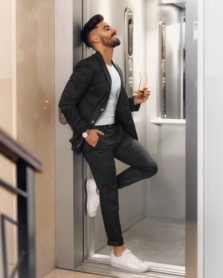 Black Vertical Striped Suit Outfits: Marry a black vertical striped suit with a white crew-neck t-shirt for a proper refined look. A trendy pair of white leather low top sneakers is a simple way to give a dose of stylish casualness to your ensemble.