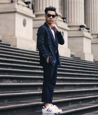 Suit Outfits In Their 20s: A suit and a white crew-neck t-shirt are absolute essentials if you're figuring out a semi-casual closet that holds to the highest fashion standards. White and black leather low top sneakers will bring a more laid-back aesthetic to an otherwise dressy look. So if you need style ideas on how to dress in your mid-20s, this pairing is definitely worth saving for later.