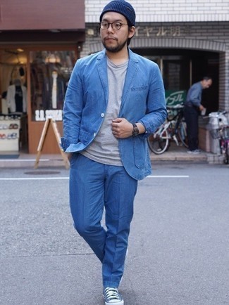 Blue Suit Outfits: A blue suit and a grey crew-neck t-shirt are the kind of a winning ensemble that you need when you have no time to spare. Wondering how to finish off? Complement this ensemble with blue canvas low top sneakers for a more relaxed take.