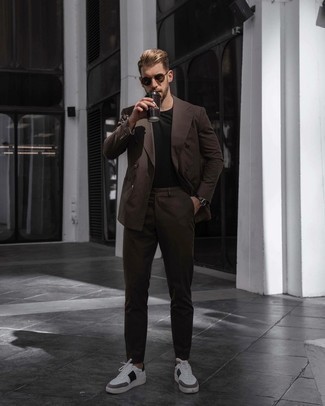 Dark Brown Suit Outfits: This pairing of a dark brown suit and a black crew-neck t-shirt is hard proof that a pared down outfit can still be truly dapper. Complete your ensemble with white and black leather low top sneakers to effortlessly kick up the wow factor of your outfit.