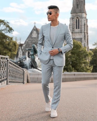 Slip-on Sneakers Outfits For Men: Marrying a grey suit and a grey horizontal striped crew-neck t-shirt is a guaranteed way to breathe personality into your styling rotation. Get a little creative in the shoe department and dress down this outfit by slipping into slip-on sneakers.