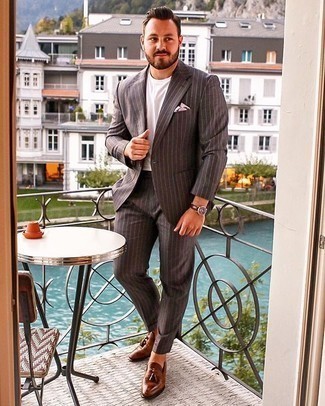 Charcoal Vertical Striped Suit Outfits: Infuse personality into your day-to-day styling arsenal with a charcoal vertical striped suit and a white crew-neck t-shirt. For a sleeker twist, why not complete this outfit with brown leather tassel loafers?