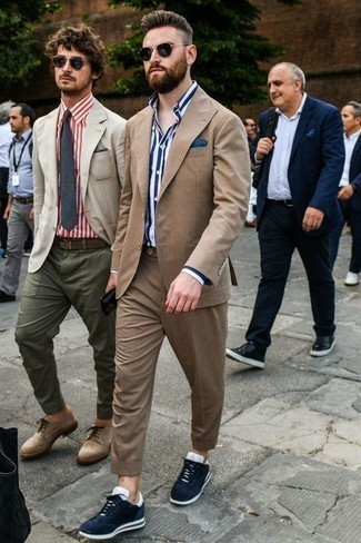 Tan Suit Outfits: A tan suit and a white and navy vertical striped dress shirt are a refined ensemble that every smart guy should have in his closet. Rev up this look by finishing with navy and white athletic shoes.