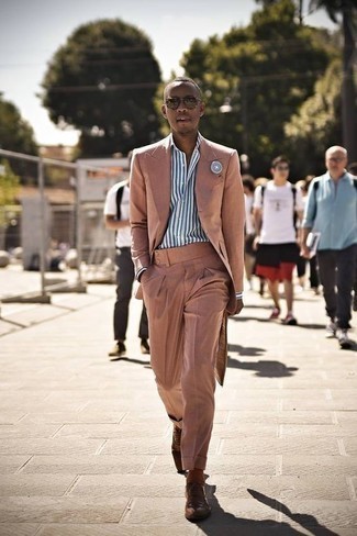 Pink Suit Outfits: Hard proof that a pink suit and a white and blue vertical striped dress shirt look awesome when worn together in a sophisticated outfit for today's man. Loosen things up and add brown leather brogues to the mix.