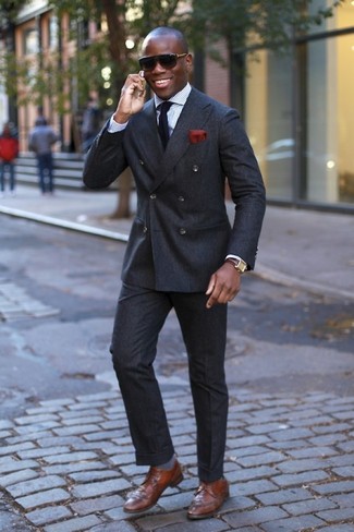 A charcoal wool suit looks so elegant when matched with a white vertical striped dress shirt. Complement your outfit with a pair of brown leather brogues to shake things up.