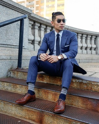 Brown Leather Brogues Outfits: When it comes to high-octane smart style, this pairing of a navy suit and a white and blue vertical striped dress shirt doesn't disappoint. Dial down the classiness of this ensemble by rounding off with brown leather brogues.