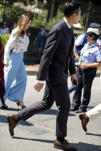 Brown Leather Brogues Outfits: This is indisputable proof that a charcoal vertical striped suit and a white dress shirt look awesome when paired up in a refined getup for today's man. Introduce a pair of brown leather brogues to the equation to instantly up the wow factor of this getup.
