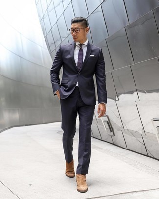 Purple Polka Dot Tie Outfits For Men: A navy vertical striped suit and a purple polka dot tie are among the foundations of any smart wardrobe. Feeling experimental? Shake things up by rocking a pair of tan suede chelsea boots.