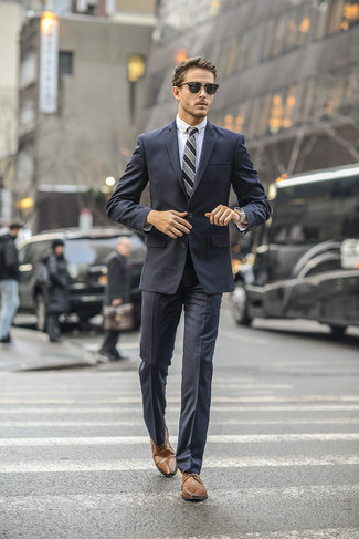 Grey Vertical Striped Tie Outfits For Men: When it comes to high-octane sophistication, this combo of a charcoal suit and a grey vertical striped tie doesn't disappoint. And if you want to effortlessly tone down your look with a pair of shoes, introduce brown leather derby shoes to the equation.