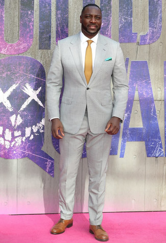 Adewale Akinnuoye-Agebaje wearing Grey Suit, White Dress Shirt, Tan Leather Derby Shoes, Mustard Tie
