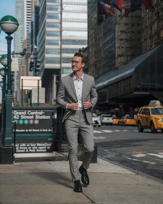 Grey Suit Outfits: Combining a grey suit and a white dress shirt is a fail-safe way to inject style into your styling routine. A pair of black leather derby shoes instantly ups the cool of this getup.