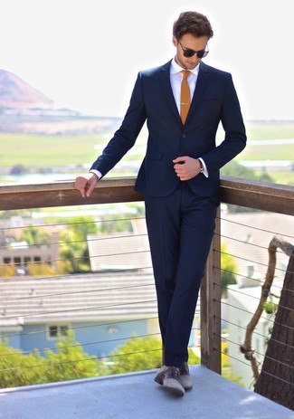 Mustard Tie Outfits For Men: Teaming a navy suit and a mustard tie is a surefire way to inject your styling arsenal with some rugged sophistication. To add a carefree touch to your look, introduce grey leather derby shoes to the mix.