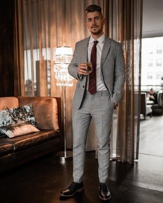 Burgundy Tie Outfits For Men: This is undeniable proof that a grey suit and a burgundy tie are awesome when teamed together in a classy ensemble for today's man. Add black leather derby shoes to the equation to infuse a touch of stylish casualness into this outfit.