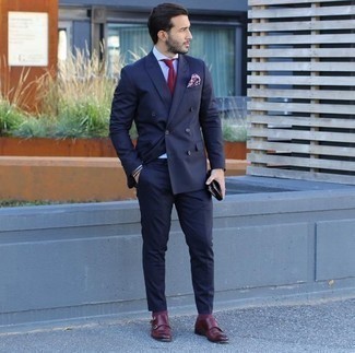Burgundy Leather Double Monks Outfits: A navy suit and a white dress shirt are strong sartorial weapons in any modern man's wardrobe. Go off the beaten track and spice up your look by rocking a pair of burgundy leather double monks.