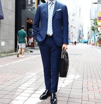 Briefcase Outfits: A navy suit and a briefcase are a go-to pairing for many fashion-forward men. Complement your ensemble with a pair of black leather double monks for a modern hi-low mix.