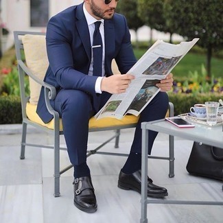 Navy Tie Outfits For Men: Pairing a navy suit with a navy tie is a smart idea for a sharp and polished outfit. For times when this outfit looks too fancy, tone it down by slipping into black leather double monks.
