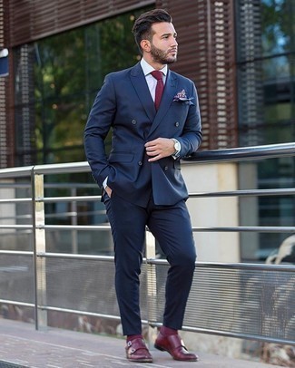 Burgundy Tie Outfits For Men: This combo of a navy suit and a burgundy tie is the definition of refinement. For an on-trend mix, add a pair of burgundy leather double monks to the mix.