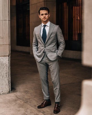 Navy Check Tie Outfits For Men: This combination of a grey suit and a navy check tie is a foolproof option when you need to look truly classy. Feeling bold? Dial down this outfit by slipping into a pair of dark brown leather double monks.