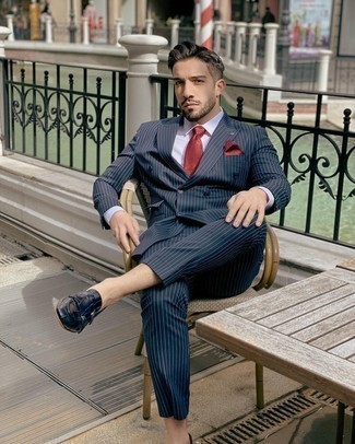 Red Tie Outfits For Men: This combo of a navy vertical striped suit and a red tie can only be described as devastatingly dapper and sophisticated. Unimpressed with this ensemble? Let a pair of navy leather double monks spice things up.