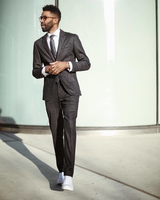 Gold Bracelet Outfits For Men: This laid-back combo of a dark brown vertical striped suit and a gold bracelet can go in different directions depending on how you style it out. For something more on the daring side to complement your ensemble, complete this outfit with white canvas high top sneakers.