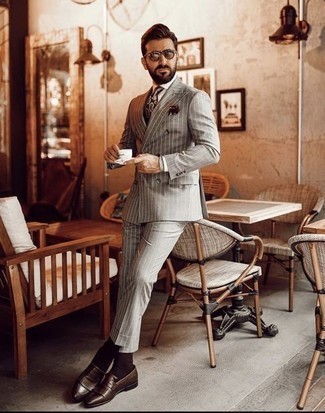 Dark Brown Paisley Tie Outfits For Men: For sharp style with a contemporary spin, dress in a grey vertical striped suit and a dark brown paisley tie. Dark brown fringe leather loafers are guaranteed to add a hint of stylish nonchalance to your outfit.