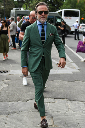 Dark Green Suit Outfits: You're looking at the indisputable proof that a dark green suit and a light blue dress shirt are awesome when teamed together in a classy look for a modern guy. To give your overall outfit a more casual feel, introduce dark brown leather loafers to the mix.