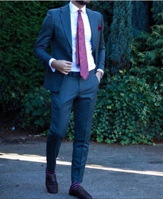 Purple Tie Outfits For Men: Combining a navy suit with a purple tie is a smart choice for a dapper and elegant ensemble. If you need to effortlessly dress down this outfit with footwear, introduce a pair of black leather loafers to the mix.