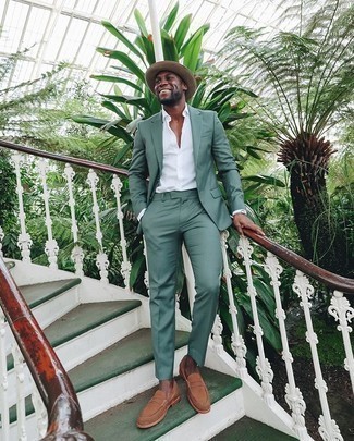Dark Green Suit Outfits: You'll be amazed at how easy it is to get dressed like this. Just a dark green suit and a white dress shirt. Tan suede loafers are an easy way to transform this look.