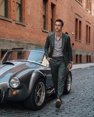 Dark Green Suit Outfits: For manly sophistication with a modern take, you can easily rock a dark green suit and a white and black check dress shirt. If not sure as to what to wear when it comes to footwear, stick to a pair of brown suede loafers.