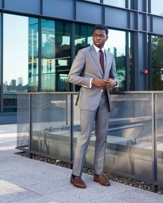 Brown Tie Outfits For Men: Marry a grey suit with a brown tie and you're bound to turn every head in the room. Make this ensemble more practical by finishing off with brown fringe leather loafers.