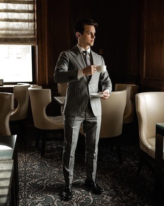 Silver Check Tie Outfits For Men: Rock a grey vertical striped suit with a silver check tie to look handsome and smart. Up this whole outfit by finishing off with black leather loafers.