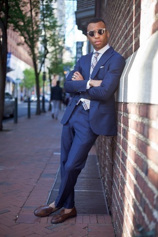 Navy Suit Outfits: Rock a navy suit with a white vertical striped dress shirt for seriously smart style. Complete this ensemble with a pair of brown leather loafers et voila, the look is complete.
