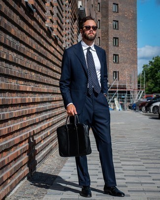 Black Leather Briefcase Outfits: A navy suit and a black leather briefcase are the kind of a foolproof casual combo that you so desperately need when you have no time. Introduce a pair of navy leather loafers to this getup for an added dose of refinement.