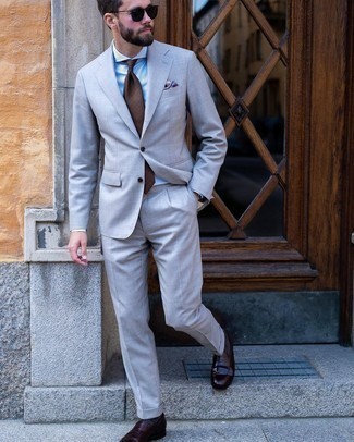 Brown Print Tie Outfits For Men: Marrying a grey suit and a brown print tie will be solid proof of your outfit coordination prowess. Dark brown leather loafers are a simple way to infuse an element of stylish nonchalance into this getup.