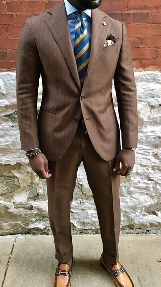 Multi colored Horizontal Striped Tie Outfits For Men: A brown vertical striped suit looks especially elegant when worn with a multi colored horizontal striped tie. On the shoe front, go for something on the relaxed end of the spectrum and finish off this getup with a pair of tobacco leather loafers.