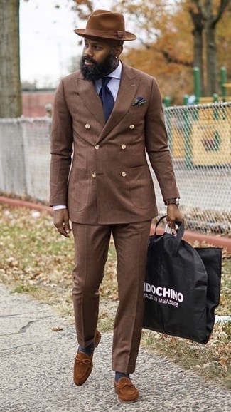 Dark Brown Suit Outfits: This pairing of a dark brown suit and a white dress shirt is a goofproof option when you need to look like a perfect gentleman. Avoid looking too polished by rounding off with a pair of brown suede loafers.