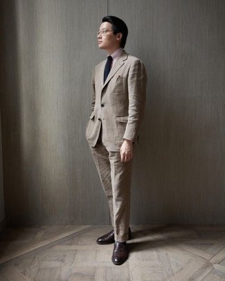 Beige Suit Outfits: This combo of a beige suit and a pink dress shirt is seriously dapper and creates instant appeal. Dark brown leather loafers will add a playful vibe to an otherwise dressy ensemble.