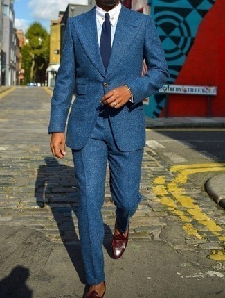 Blue Suit Outfits: Definitive proof that a blue suit and a light blue dress shirt are amazing when worn together in an elegant outfit for a modern gentleman. A pair of burgundy fringe leather loafers instantly ramps up the wow factor of your ensemble.