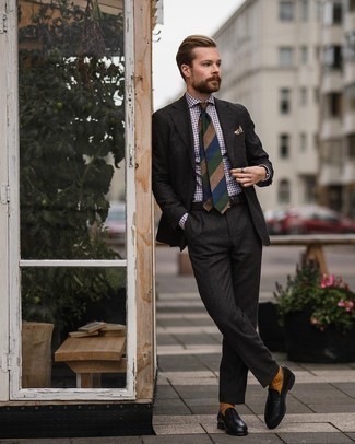 Multi colored Horizontal Striped Tie Outfits For Men: Opt for a charcoal suit and a multi colored horizontal striped tie to look like a refined gent with a good deal of class. Go ahead and complete your outfit with black leather loafers for a playful feel.